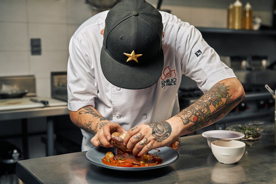Professional chef carefully plating gourmet event food