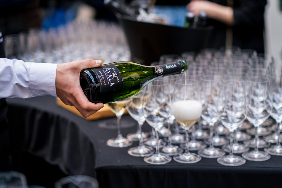 Bartender pouring champagne for a corporate catering event